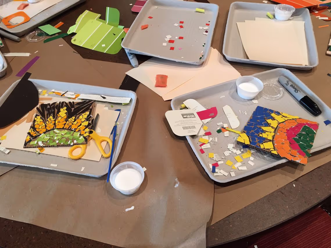 A table topped with trays of art supplies